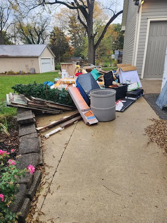Dumpster being loaded with debris for Roofing Dumpster Rental in Mathis